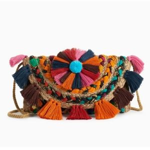 CROSSBODY BAG WITH TASSELS AND POM.